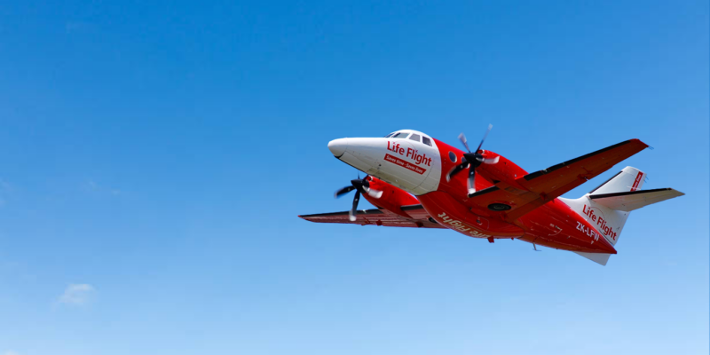 Life Flight Plane in air with blue sky